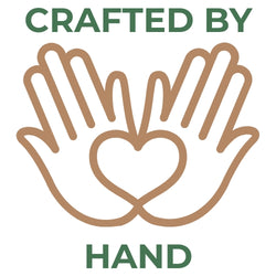 Green text reading Crafted By Hand surrounding a brown line-art icon of two cupped hands forming a heart shape.