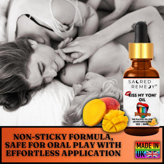 Amber glass dropper bottle of Kiss My Yoni Mango oil with fresh mango slices against a soft-focus romantic background.