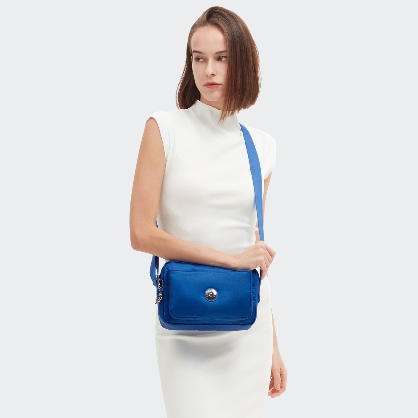 Buy Kipling Abanu M Crossbody Shoulder Bag | Satin Blue Handbag - Discover the perfect everyday companion with the Kipling Abanu M crossbody bag in stunning satin blue. This versatile shoulder bag offers ample space for essentials while maintaining a sleek, stylish look. Crafted with Kipling's signature lightweight and durable material, it's the ideal accessory for any occasion. at Sacred Remedy Online