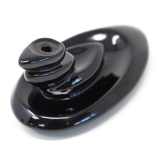 Glossy black ceramic backflow incense burner with a smooth, tiered pebble design on an oval base.