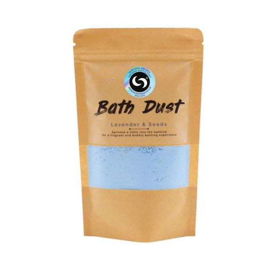 Lavender and Seeds bath dust in a brown kraft pouch with a clear window showing light purple powder.