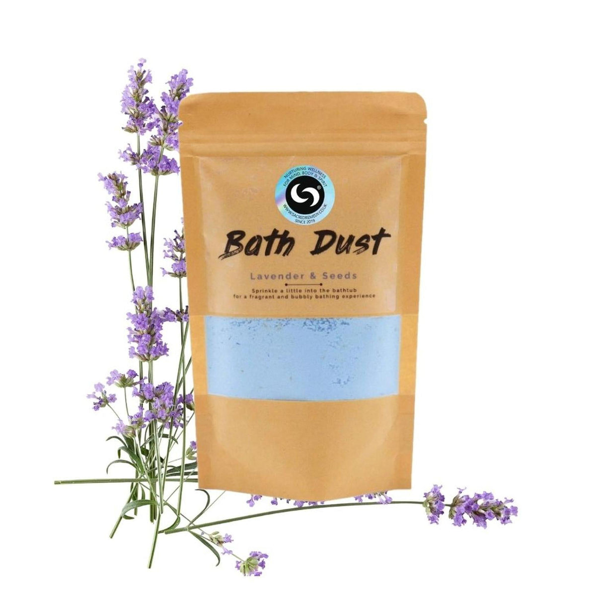 Lavender and Seeds bath dust in a brown kraft pouch with a clear window, displayed next to fresh lavender sprigs.