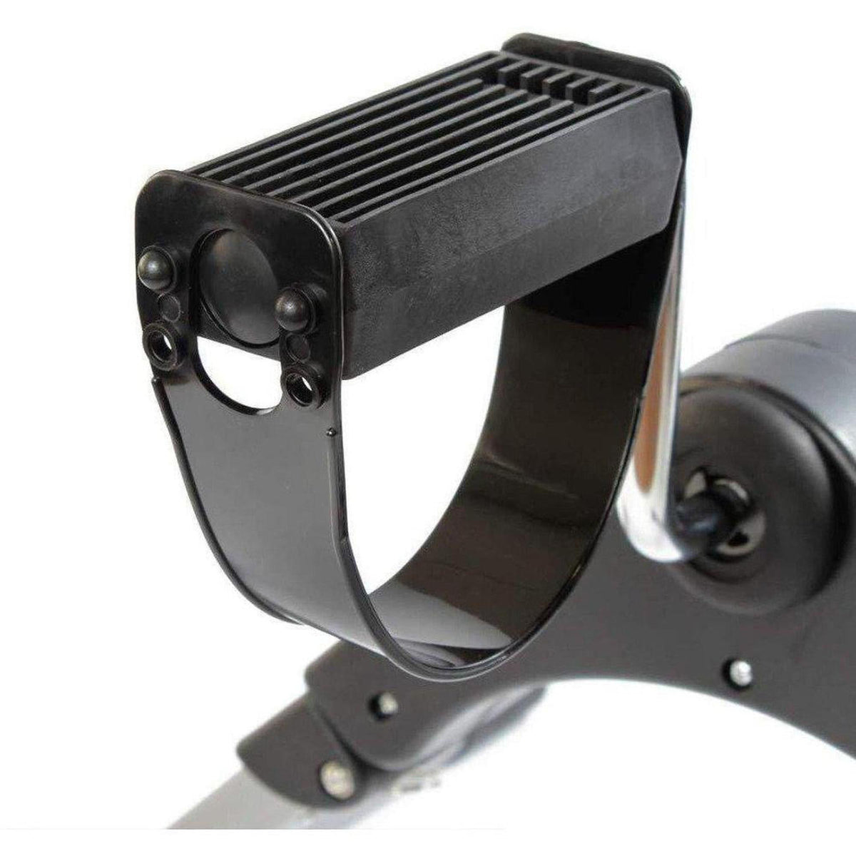 Black textured plastic pedal with a curved support strap on a portable digital exercise machine.