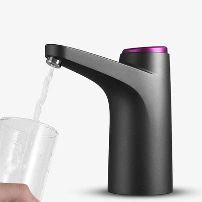 Matte black electric water dispenser with a purple top button and stainless steel spout filling a glass.