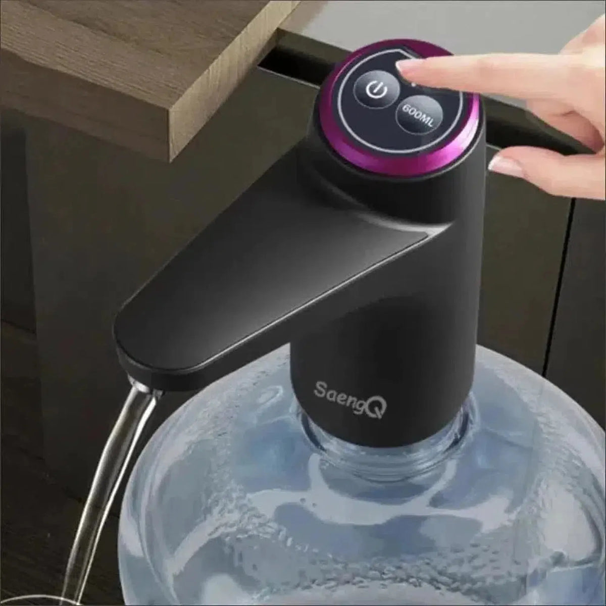 Black electric water dispenser pump with a purple accent ring and stainless steel spout on a large water jug.