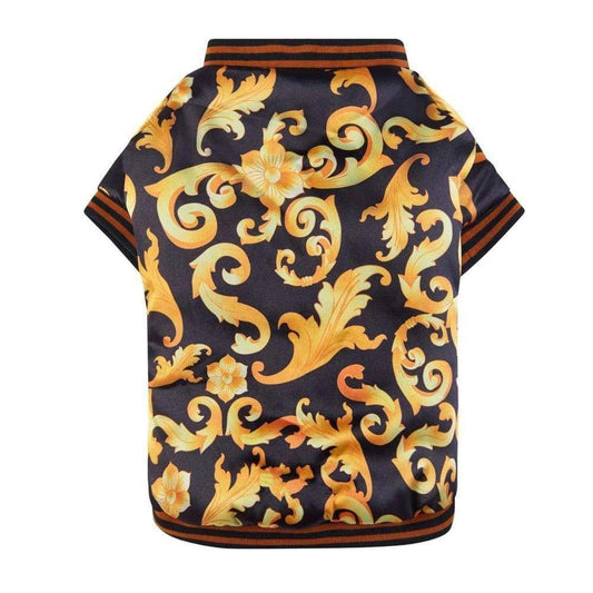 Black satin dog bomber jacket with ornate gold baroque filigree print and striped ribbed knit trim.