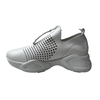 White leather Harmony sneakers featuring a front zip closure, perforated side panels, and a chunky platform sole.