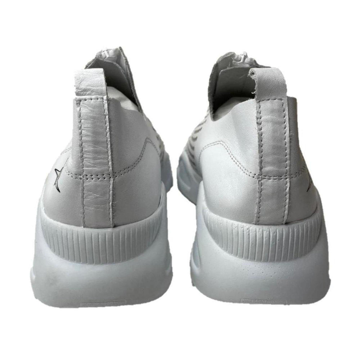 Back view of white genuine leather Harmony sneakers with thick soles and a zip-front design against a white background.