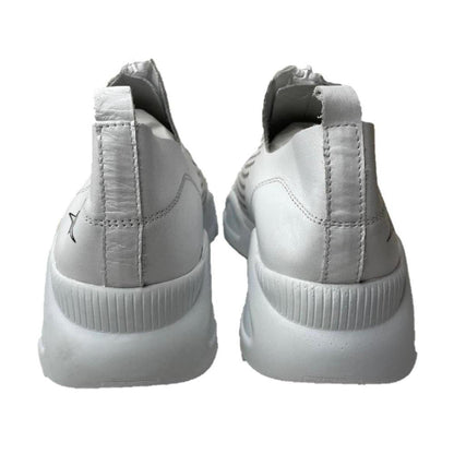 Back view of white genuine leather Harmony sneakers with thick soles and a zip-front design against a white background.