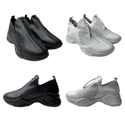 Black and white perforated leather sneakers featuring a convenient front-zip closure and chunky athletic soles.
