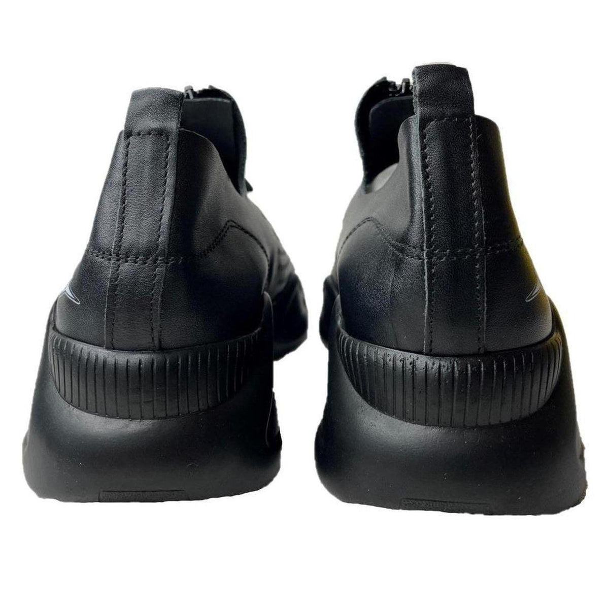 Back view of black leather Harmony sneakers with a thick, ribbed sole and minimalist design.