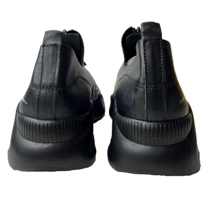Back view of black leather Harmony sneakers with a thick, ribbed sole and minimalist design.
