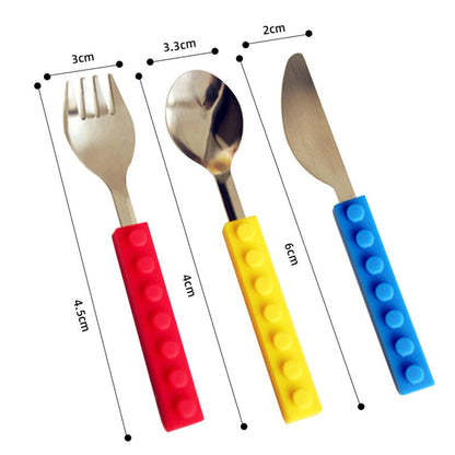 Stainless steel fork, spoon, and knife set with colorful, interlocking silicone building block handles.