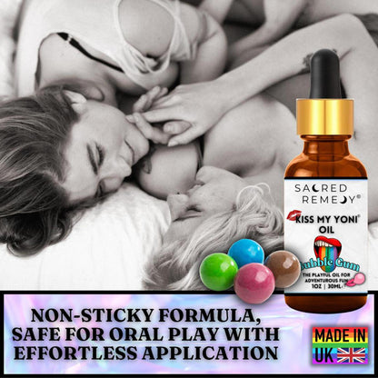 Amber glass bottle of Kiss My Yoni Bubblegum oil with a dropper, surrounded by colorful gumballs against a romantic backdrop.
