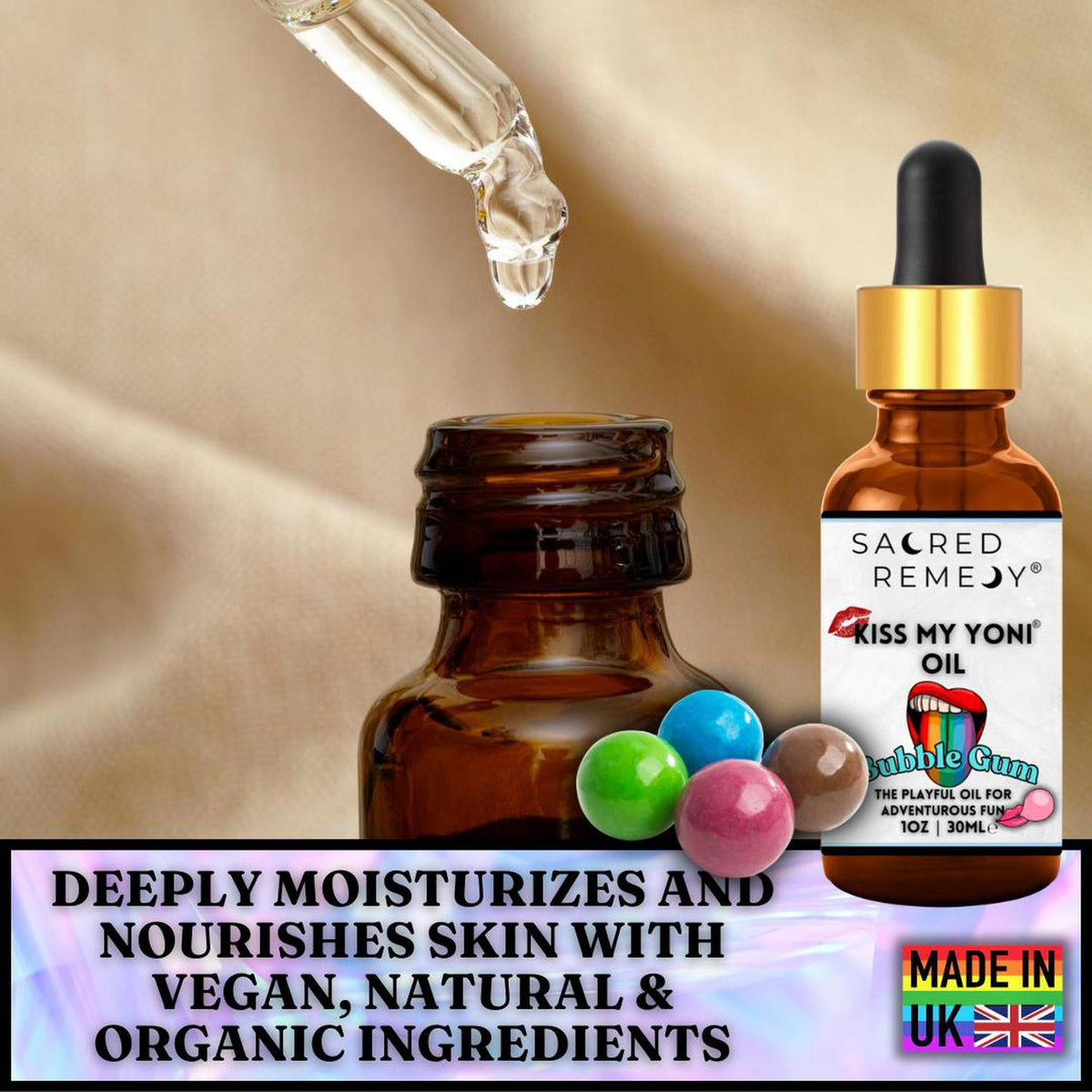 Amber glass dropper bottle of Kiss My Yoni Bubblegum oil with colorful gumballs on a soft beige fabric background.