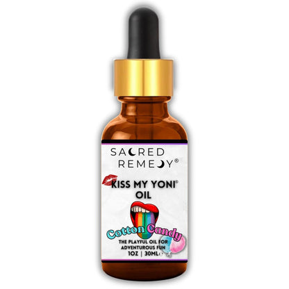 Amber glass dropper bottle of Kiss My Yoni Oil in Cotton Candy with a gold cap and a playful, colorful label design.