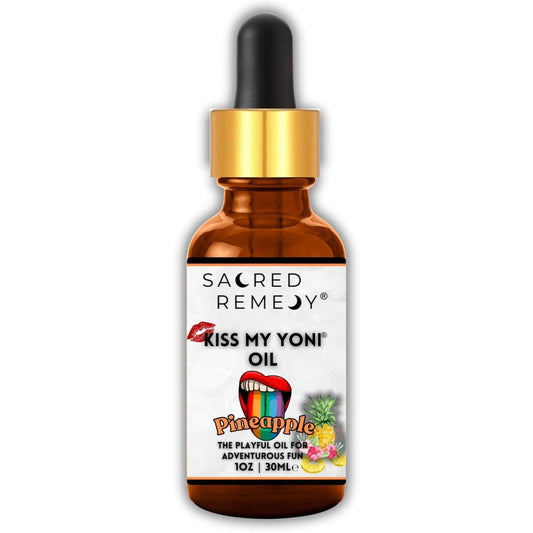 Amber glass dropper bottle of Kiss My Yoni Pineapple oil with a vibrant rainbow tongue and pineapple label design.