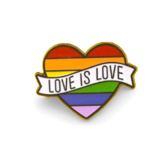 Heart-shaped rainbow enamel pin with a white banner reading Love Is Love in black text and a gold metal border.