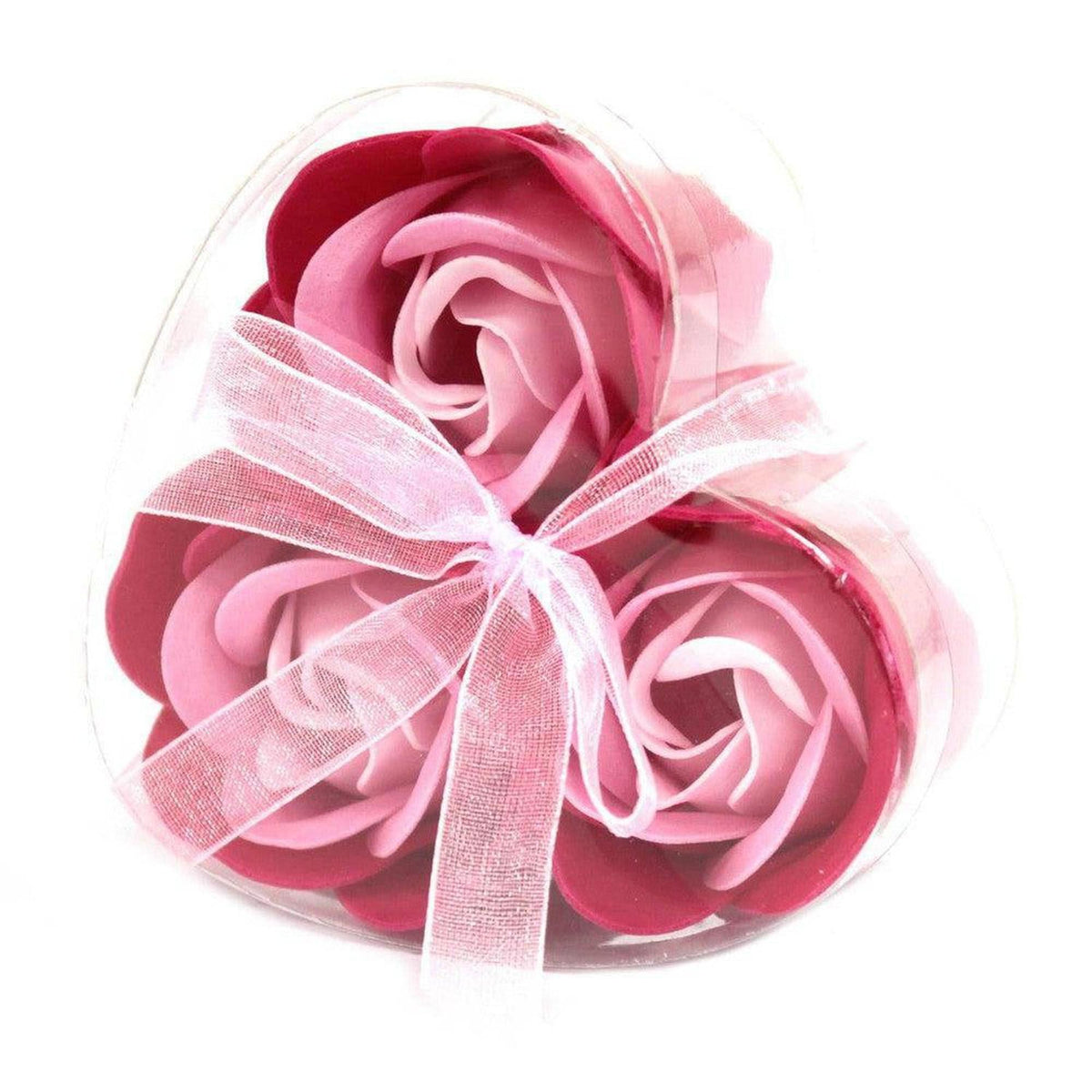 Three pink rose soap flowers in a clear heart-shaped gift box tied with a delicate sheer ribbon.