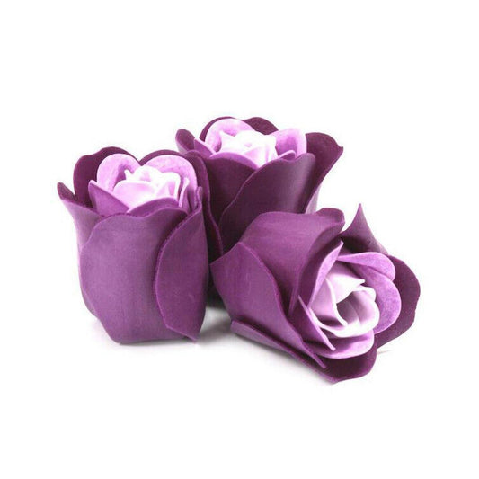 Three handcrafted purple and lavender soap roses with delicate, lifelike petals isolated on a white background.