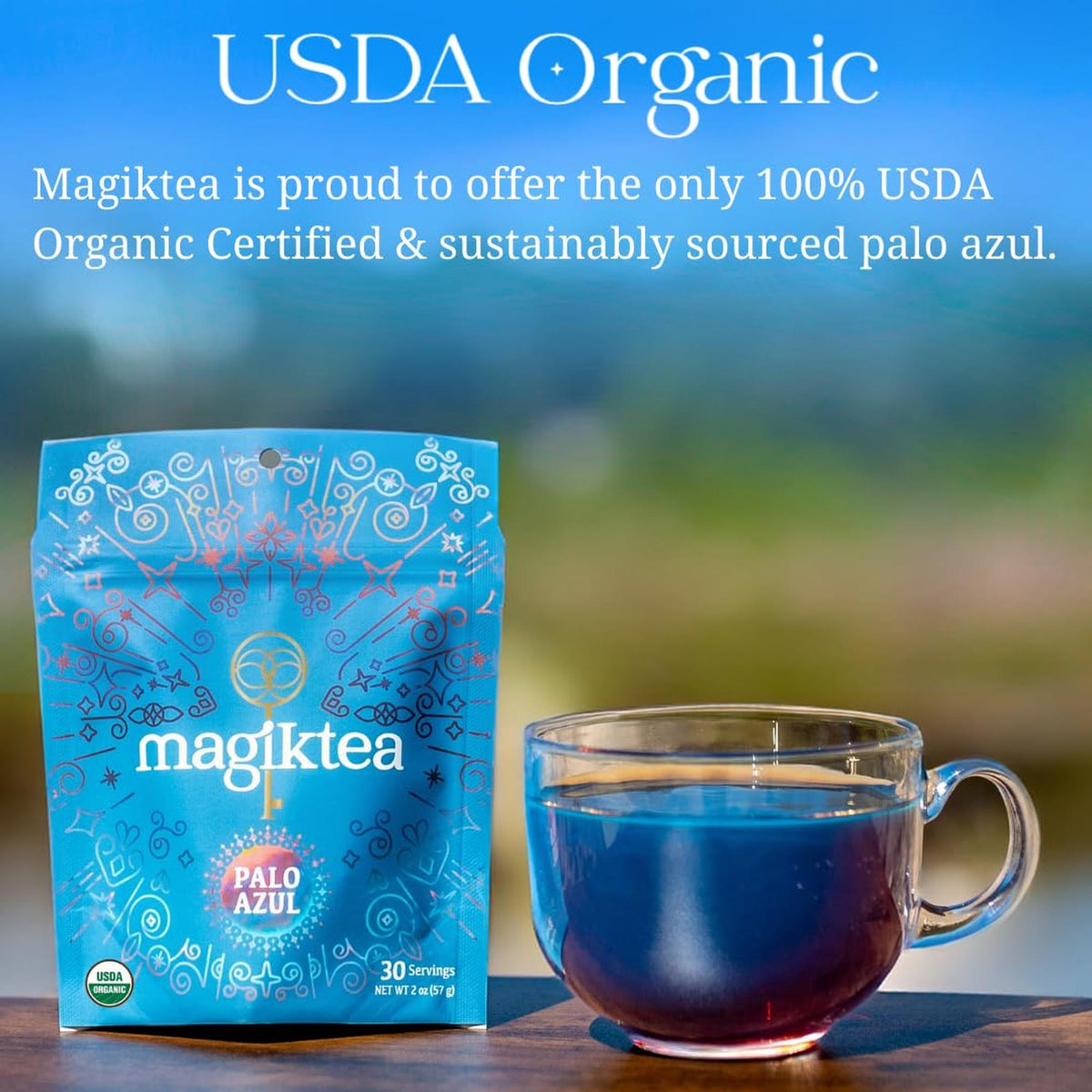 Magiktea Palo Azul pouch next to a clear glass mug filled with glowing, fluorescent blue herbal tea.