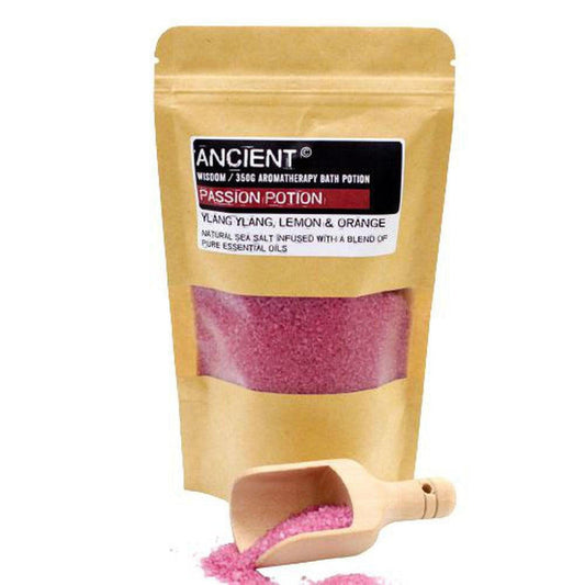 350g pouch of pink Passion Potion sea salt bath soak with a small wooden scoop on a white background.