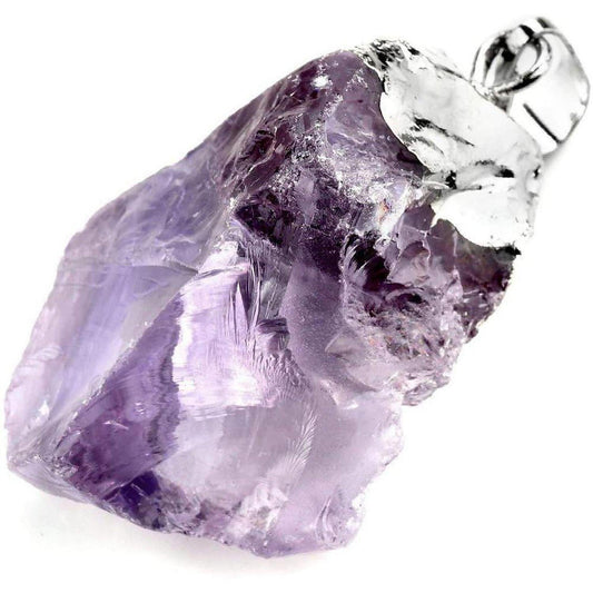 Raw purple amethyst crystal pendant with a silver bail on a white background.
