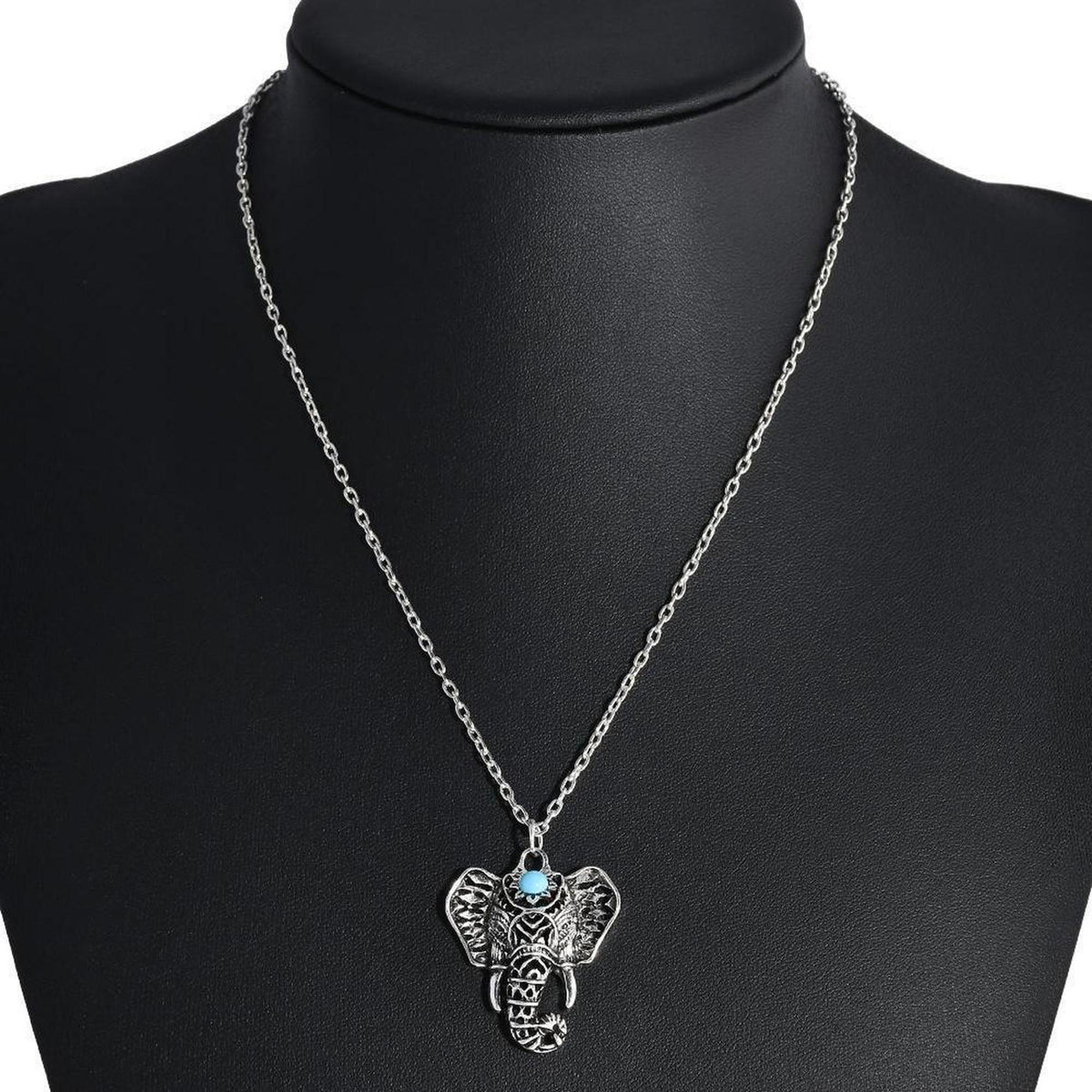 Antique silver-plated elephant pendant necklace featuring a small blue stone on a delicate chain.