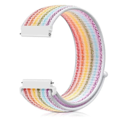Adjustable rainbow nylon loop strap for Apple Watch with white connectors and a soft, breathable woven texture.