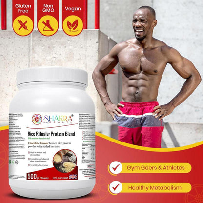 Muscular man standing next to a 500g tub of Shakra Health Rice Rituals chocolate brown rice protein powder.