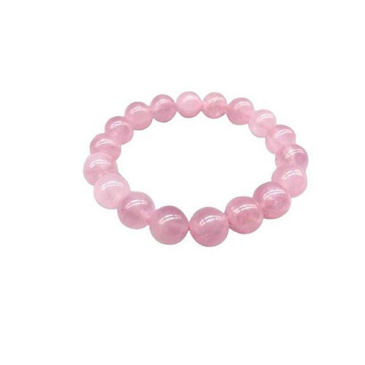 Stretch bracelet made of polished 10mm blush-pink rose quartz gemstone beads on a white background.