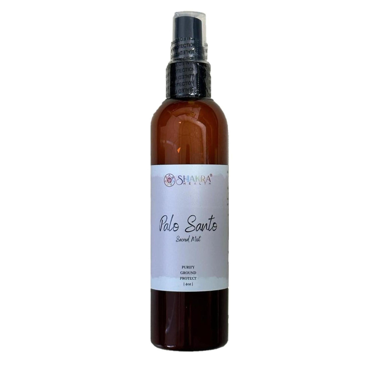Amber 4oz spray bottle of Shakra Health Palo Santo Sacred Mist with a white minimalist label and black pump top.