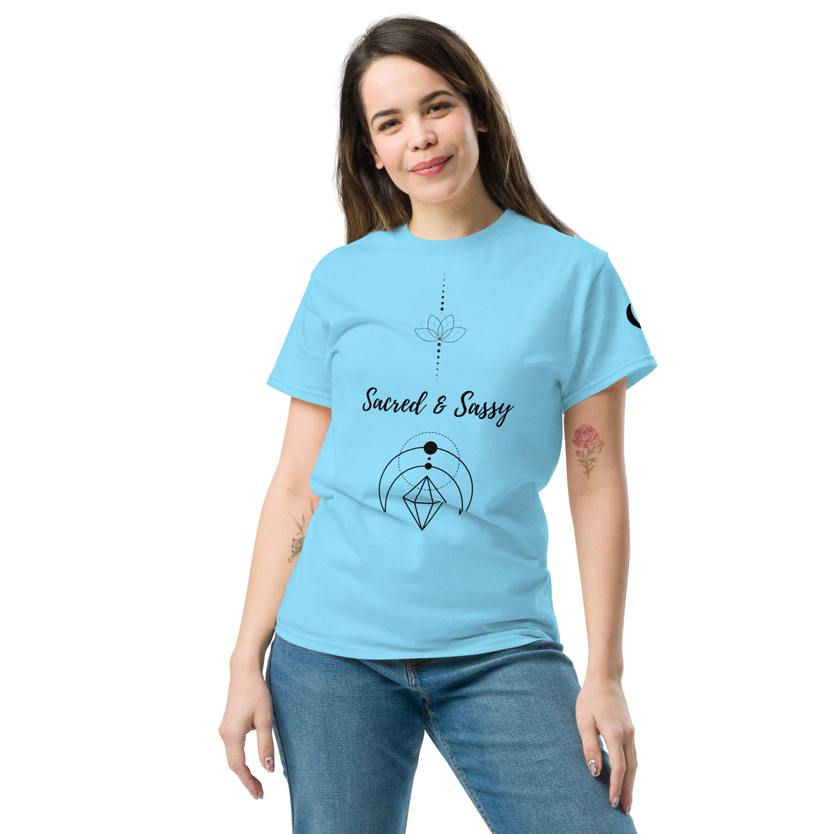 Woman wearing a light blue cotton unisex t-shirt featuring a black Sacred & Sassy lotus and geometric design.