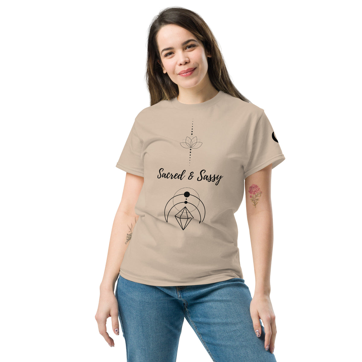 Woman wearing a beige cotton unisex t-shirt with a black Sacred & Sassy lotus and geometric graphic design.