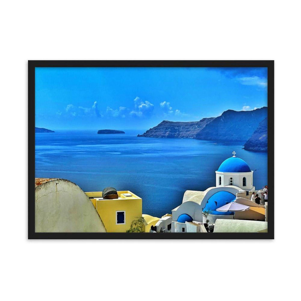 Framed Santorini landscape print featuring blue-domed churches and yellow architecture overlooking the Aegean Sea.