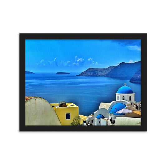 Framed Santorini landscape print featuring blue-domed churches and yellow buildings overlooking the Aegean Sea.