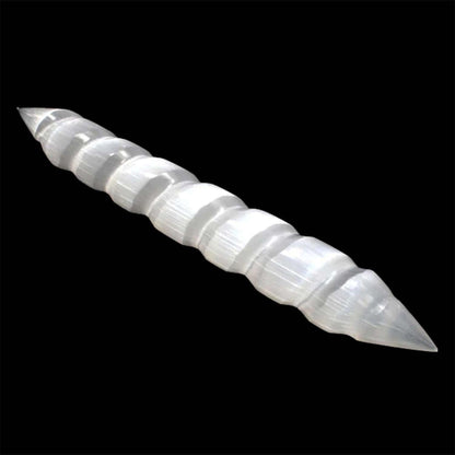 Milky white selenite massage wand with a spiral design and double pointed ends against a black background.