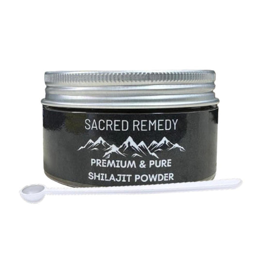 Black jar of Sacred Remedy Shilajit powder with a silver screw-top lid and a small white measuring scoop in front.