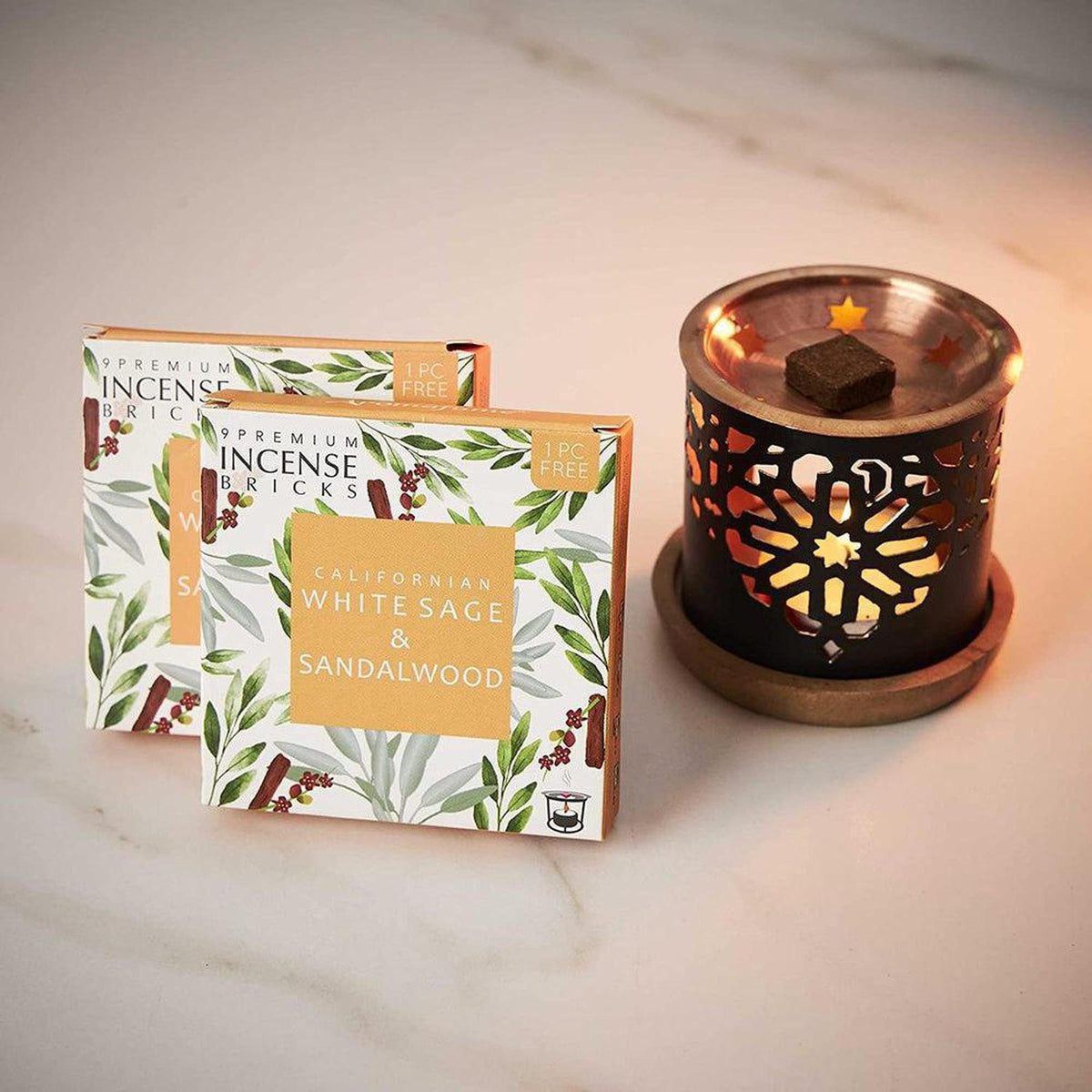Smokeless copper incense burner with a tea light and two boxes of Californian White Sage and Sandalwood incense bricks.