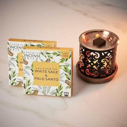 Smokeless incense burner with a copper plate and two boxes of White Sage and Palo Santo aromatic bricks.