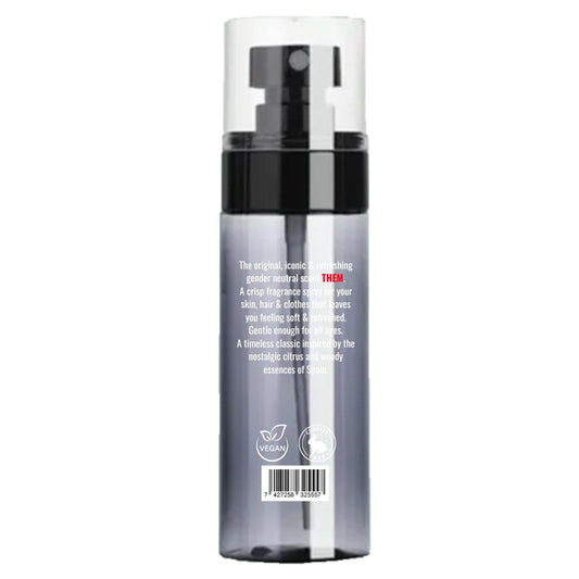 Clear spray bottle of THEM Agua de Colonia with black pump, white text, and vegan and cruelty-free icons on a gray base.