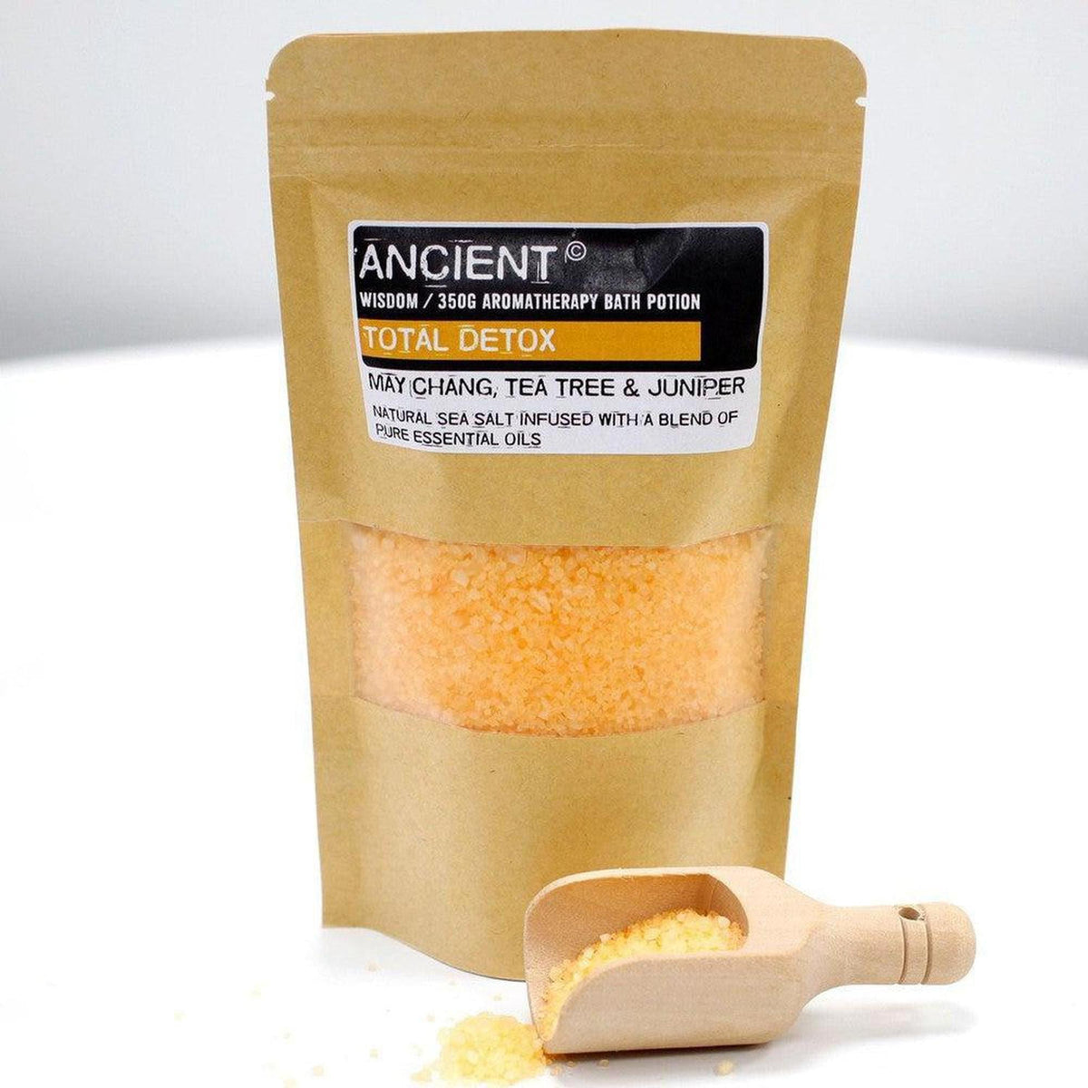 350g pouch of orange Total Detox aromatherapy sea salt with a wooden scoop on a white background.