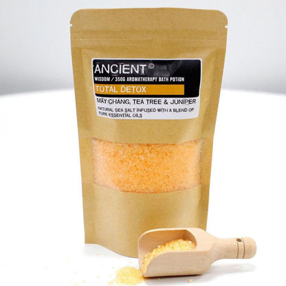 350g pouch of orange Total Detox aromatherapy sea salt with a wooden scoop on a white background.