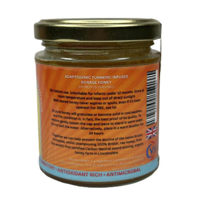 Glass jar of turmeric-infused borage honey with an orange label detailing ingredients and British origin.
