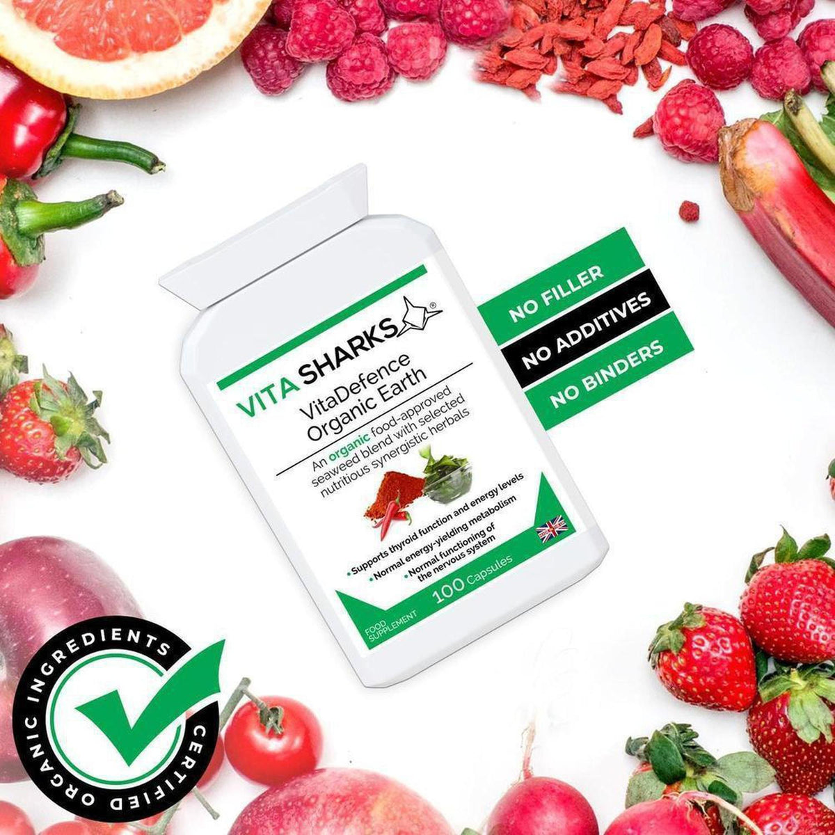 VitaDefence Organic Earth supplement bottle surrounded by fresh strawberries, rhubarb, and grapefruit on a white background.